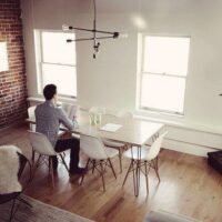 man sitting at table alone reading